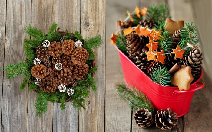 Korb und Schale mit Zweigen und Tannzapfen als Weihnachtsdeko auf dem Tisch