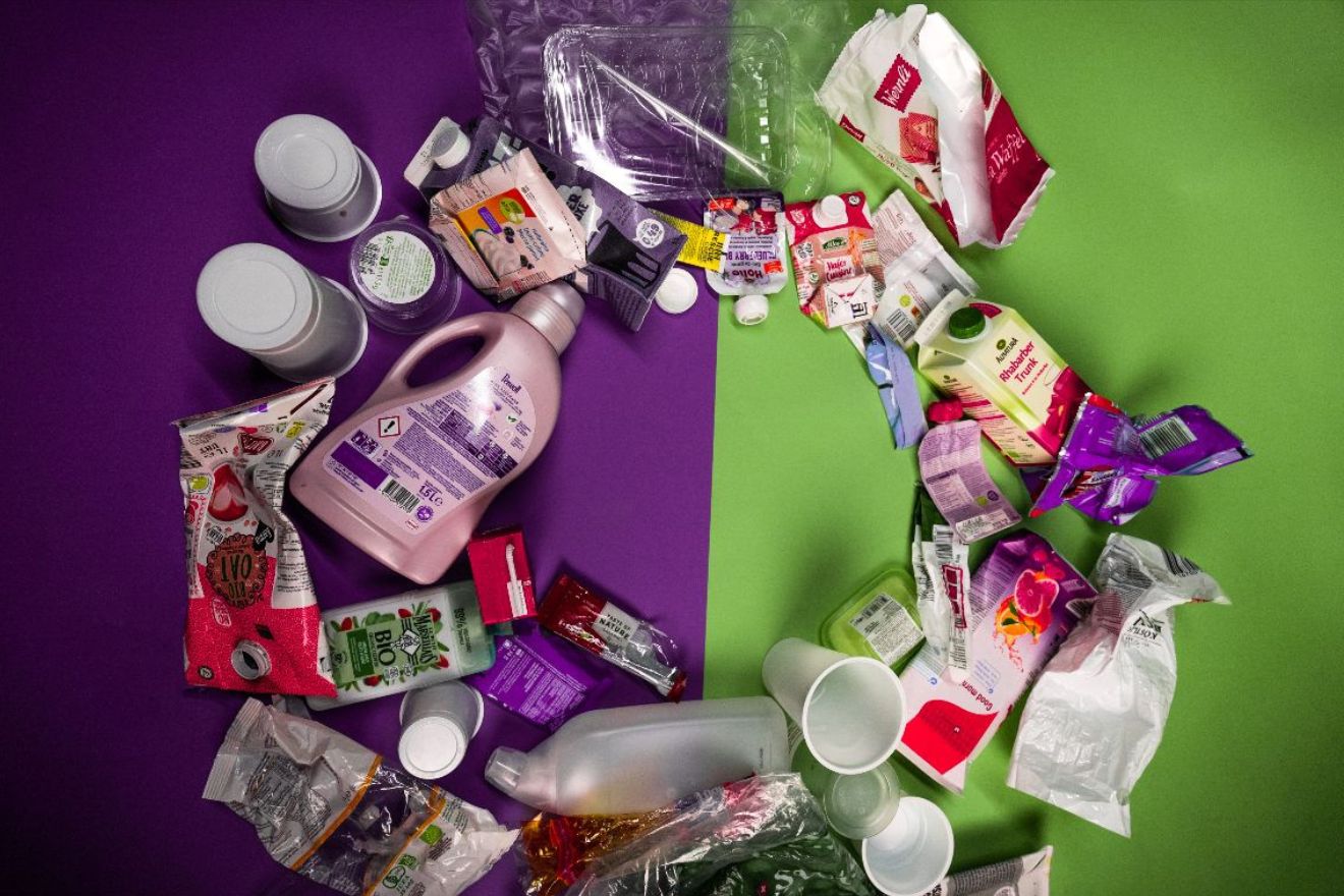 verschiedene Kunststoffprodukte liegen in einem Kreis verteilt auf einem violett-grünen Hintergrund