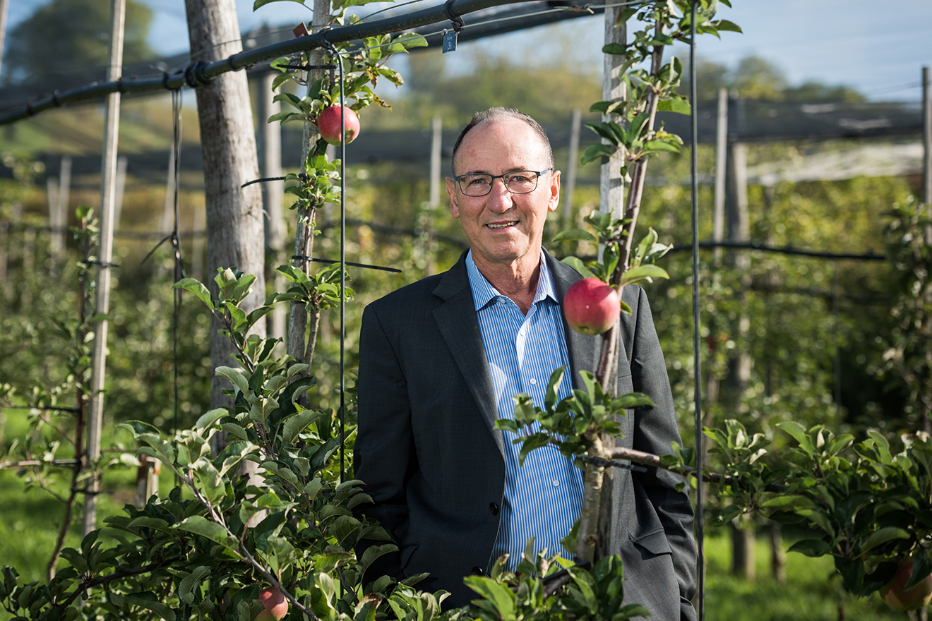 Prof. Dr. Dr. Urs Niggli zwischen Apfelbäumen.